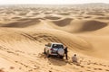 Travel guide men with four wheel drive car on the great desert at Dubai Royalty Free Stock Photo