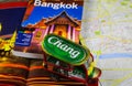 Travel guide, photo book, model of tuk tuk and city map for planning a trip to Bangkok