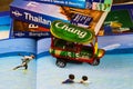 Travel guide, photo book, model of tuk tuk and city map for planning a trip to Thailand