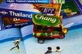 Travel guide, photo book, model of tuk tuk and city map for planning a trip to Thailand