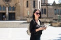 Travel guide, tourism in Europe, woman tourist with map on the street. Royalty Free Stock Photo