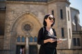 Travel guide, tourism in Europe, woman tourist with map on the street. Royalty Free Stock Photo