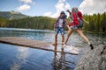 travel hikers in love enjoying the nature while playing with water in the lake of the mountain