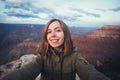 Travel hiking selfie photo of young beautiful teenager student at Grand Canyon viewpoint in Arizona