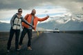 Travel hitchhiker couple on a road