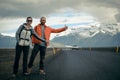 Travel hitchhiker couple on a road