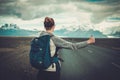 Travel hitchhiker woman walking on a road Royalty Free Stock Photo
