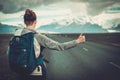 Travel hitchhiker woman walking on a road