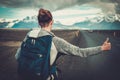 Travel hitchhiker woman walking on a road