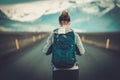 Travel hitchhiker woman walking on a road Royalty Free Stock Photo