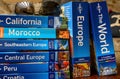 Travel and holiday image. A collection of travel guides sit on a table Royalty Free Stock Photo