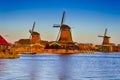 Travel Ideas.Line of Traditional Dutch Windmills in the Village of Zaanse Schans at Daytime in the Netherlands Royalty Free Stock Photo