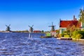 Travel Ideas. Line of Traditional Dutch Windmills in the Village of Zaanse Schans, in the Netherlands at Daytime Royalty Free Stock Photo