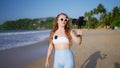 Travel influencer films beach vlog using pro camera, lav mic, sharing tips, capturing scenic landscape, engaging viewers