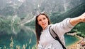 Travel influencers. Beautiful young woman blogger with smartphone on summer nature background. Mountain rock landscape Royalty Free Stock Photo