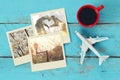 Travel instant photographs next to cup of coffee and airplane Royalty Free Stock Photo