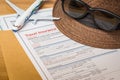 Travel Insurance Claim application form and hat with eyeglass on Royalty Free Stock Photo