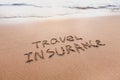 Travel insurance concept, text on sand Royalty Free Stock Photo