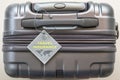 Travel insurance protection plan for airline safety and security with tag on passenger suitcase luggage handle