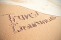 Travel Insurance text written on sand Royalty Free Stock Photo