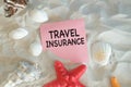 Travel Insurance word on Paper is written on the beach sand. Royalty Free Stock Photo
