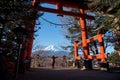 Travel Japan on winter, Woman raised hands with a giant torii gate or Red pole and fuji mountains