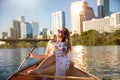 Travel and leisure commercial model, woman on canoe boat kayak relaxing enjoying summer fun day on river in Austin downtown