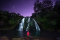 Travel lifestyle concept waterfall, lake and mountains night sky landscape on background outdoor