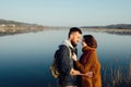 Romance and rest. A loving couple near a blue lake Royalty Free Stock Photo