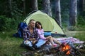 Travel, love and living in nature concept. Sensual young couple in love roasting sweet marshmallow in fire and have fun Royalty Free Stock Photo