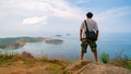 Travel man photographer standing on rock to see landscape view at Phahindum viewpoint popular landmark in Phuket Thailand