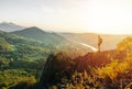 Travel man tourist alone on the edge cliff mountains and looking on the valley Royalty Free Stock Photo