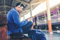 Travel man using mobile listening music phone and at train station Royalty Free Stock Photo