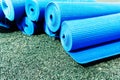 Blue polyurethane foam mats for sports and hiking lie on a rubber backing. Close-up