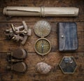 Travel and nautical theme grunge background. Old map, compass, shell, sextant, old coins on wood desk. Antique set. Travel,