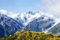 Travel New Zealand, Mount Fox. Scenic view of southern alps, mount cook and glaciers. Small person / tourist woman with hands up e Royalty Free Stock Photo