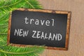 Travel New Zealand palm trees and blackboard on sandy beach Royalty Free Stock Photo