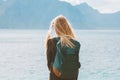 Travel in Norway globetrotter woman with backpack looking at mountains view alone outdoor