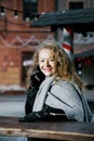 Travel the old city. A young woman travels. Market Square in Warsaw. Curly girl walks through the streets of the city.