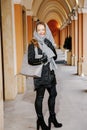 Travel the old city. A young woman travels. Market Square in Warsaw. Curly girl walks through the streets of the city.