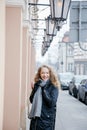 Travel the old city. A young woman travels. Market Square in Warsaw. Curly girl walks through the streets of the city.