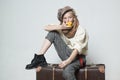 Travel with old suitcase. Homelss. old fashioned child in beret eat apple. retro fashion model. Vintage suspender. teen