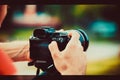 Travel photographer with camera in hand make photo outdoor Royalty Free Stock Photo