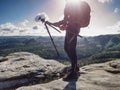 Travel photographer on mountain summit works. Man like