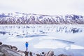 Travel photographer taking photo of snowy landscape in Norway in spring Royalty Free Stock Photo