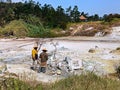 people boiling eggs in geyser at Kawah Sikidang crater