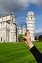 Travel photography: The tourist takes a photo of the famous leaning Pisa Tower using a mobile phone. Royalty Free Stock Photo