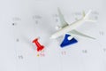 Travel planning with airplane destination points on a map red pin holiday on calendar - travel time or plan for travelling concept Royalty Free Stock Photo