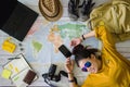 Travel planning concept with map. Overhead view of equipment for travelers. Background travel ideas young women sleeping smiling