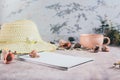 Travel planning notebook, hat, seashells and cup of coffee on table Royalty Free Stock Photo